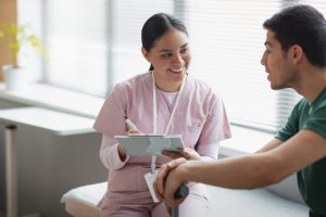 doctor-helping-patient-rehabilitation-1-scaled.jpg